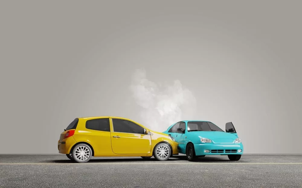 Concept of T-bone accident with two toy cars colliding